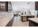 Modern kitchen with stainless steel appliances, island, and views of the living room, perfect for entertaining guests and Gathering at 10726 E Tallahassee Ave, Mesa, AZ 85212