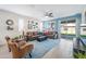 Bright living room featuring a ceiling fan, stylish furniture, sliding glass doors, and light-colored walls for a cozy feel at 10726 E Tallahassee Ave, Mesa, AZ 85212