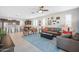Bright living room with an open layout to the kitchen, plush seating, and a ceiling fan, ideal for Gathering time at 10726 E Tallahassee Ave, Mesa, AZ 85212