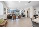 Spacious open-concept living room with tile flooring, seamlessly connecting to the kitchen and offering ample natural light at 10726 E Tallahassee Ave, Mesa, AZ 85212