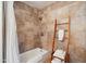 Bathroom showcasing tile surround tub, shower and rustic decor, complete with stacked towel storage at 10810 E San Salvador Dr, Scottsdale, AZ 85259