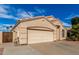 Single-story home with a two-car garage and low-maintenance desert landscaping at 11406 W Piccadilly Rd, Avondale, AZ 85392