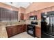 Efficient kitchen with granite countertops and modern black appliances at 11406 W Piccadilly Rd, Avondale, AZ 85392