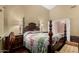 Comfortable main bedroom with a four-poster bed, side tables, and an ensuite entrance at 11406 W Piccadilly Rd, Avondale, AZ 85392