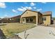 Spacious backyard featuring a large patio, well-maintained lawn, and desert landscaping at 11933 W Daley Ln, Sun City, AZ 85373