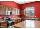 Well-lit kitchen features stainless steel appliances and granite countertops at 11933 W Daley Ln, Sun City, AZ 85373