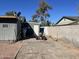 Backyard featuring a weathered ATV and a gray shed between neighboring houses at 12001 N 35Th N St, Phoenix, AZ 85028