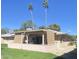 Backyard view featuring a covered patio and lush landscaping, perfect for outdoor living at 12543 W Brandywine W Dr, Sun City West, AZ 85375