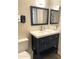 Stylish bathroom featuring a dark blue vanity with white countertop and modern fixtures at 12543 W Brandywine W Dr, Sun City West, AZ 85375