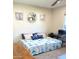 Comfortable bedroom featuring a bright, patterned quilt and charming lighthouse wall art at 12543 W Brandywine W Dr, Sun City West, AZ 85375