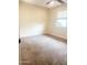 Bedroom features neutral carpet and paint, ceiling fan, and window at 12543 W Brandywine W Dr, Sun City West, AZ 85375