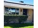 Charming front porch with brick accents and security door, surrounded by lush greenery at 12543 W Brandywine W Dr, Sun City West, AZ 85375