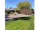 Manicured front yard with desert landscaping and mature trees offering a tranquil setting at 12543 W Brandywine W Dr, Sun City West, AZ 85375