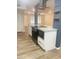 Modern kitchen with a kitchen island, stainless steel appliances, and white cabinets with black hardware at 12543 W Brandywine W Dr, Sun City West, AZ 85375