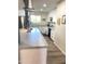 This well-lit kitchen boasts white cabinets, stainless steel appliances, and modern flooring at 12543 W Brandywine W Dr, Sun City West, AZ 85375