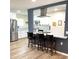 Bright kitchen features white cabinets, stainless appliances, and an island with bar stool seating at 12543 W Brandywine W Dr, Sun City West, AZ 85375