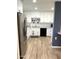 This well-lit kitchen boasts white cabinets, stainless steel appliances, and modern flooring at 12543 W Brandywine W Dr, Sun City West, AZ 85375