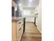 Spacious kitchen with white cabinets, stainless steel appliances, granite countertops, and wood flooring at 12543 W Brandywine W Dr, Sun City West, AZ 85375