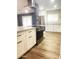Updated kitchen with white cabinets, stainless steel appliances, granite countertops, and modern fixtures at 12543 W Brandywine W Dr, Sun City West, AZ 85375