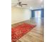 Open living area with sliding glass doors, accent wall, ceiling fan, and wood-look flooring at 12543 W Brandywine W Dr, Sun City West, AZ 85375