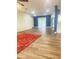 Open-concept living area with bright lighting, accent wall, sliding glass doors, and wood-look flooring at 12543 W Brandywine W Dr, Sun City West, AZ 85375