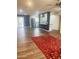 Spacious living room with an open floor plan, accent wall, stainless steel refrigerator, and wood flooring at 12543 W Brandywine W Dr, Sun City West, AZ 85375