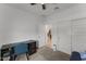 Bright bedroom with a ceiling fan, large closet, desk and view to the hallway at 13171 W Buckskin Trl, Peoria, AZ 85383