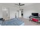 Spacious bedroom features a ceiling fan, carpet flooring, and access to an ensuite bathroom at 13171 W Buckskin Trl, Peoria, AZ 85383