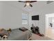 Comfortable carpeted bedroom with ceiling fan, window and view to the hallway at 13171 W Buckskin Trl, Peoria, AZ 85383
