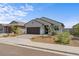 Inviting single-story home featuring a two-car garage and low-maintenance desert landscaping at 13171 W Buckskin Trl, Peoria, AZ 85383