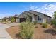Charming single-story house with a well-maintained front yard and desert landscaping at 13171 W Buckskin Trl, Peoria, AZ 85383
