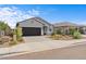 Charming single-story home featuring a two-car garage and a low maintenance landscaped front yard at 13171 W Buckskin Trl, Peoria, AZ 85383