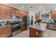 Modern kitchen features stainless steel appliances, granite countertops, a breakfast bar and lots of cabinet space at 13171 W Buckskin Trl, Peoria, AZ 85383