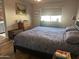 Comfortable bedroom featuring a large window, wooden floors and classic decor at 13801 N 111Th Ave, Sun City, AZ 85351