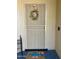 Charming front door with decorative wreath and welcome mat adding curb appeal at 13801 N 111Th Ave, Sun City, AZ 85351