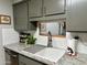 Kitchen sink with modern faucet, white backsplash, and granite countertops for a sleek design at 13801 N 111Th Ave, Sun City, AZ 85351