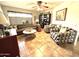 Inviting living room featuring tile floors, a comfortable sofa, and patterned armchairs at 13801 N 111Th Ave, Sun City, AZ 85351