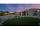 Lovely backyard with artificial grass, patio, lush landscaping, and a spiral staircase at 14562 W Georgia Ave, Litchfield Park, AZ 85340