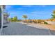 Beautifully landscaped backyard featuring a spiral staircase and custom hardscape design at 14562 W Georgia Ave, Litchfield Park, AZ 85340