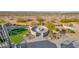 Backyard fire pit area with artificial turf, landscaping, and a seating area at 14562 W Georgia Ave, Litchfield Park, AZ 85340
