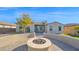 Stylish backyard with a fire pit, spiral staircase, and modern desert landscaping at 14562 W Georgia Ave, Litchfield Park, AZ 85340