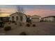 Charming single-story home with a well-manicured desert landscape and a brick driveway at 14562 W Georgia Ave, Litchfield Park, AZ 85340