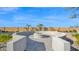 Backyard fire pit with desert landscaping and palm trees creating a cozy outdoor space at 14562 W Georgia Ave, Litchfield Park, AZ 85340