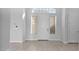 Bright foyer featuring tile flooring, arched windows, and a front door at 14562 W Georgia Ave, Litchfield Park, AZ 85340