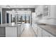 Spacious white kitchen features stainless steel appliances, granite countertops, and backyard views at 14562 W Georgia Ave, Litchfield Park, AZ 85340
