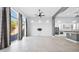 Light-filled living room with backyard access, tile flooring, and open concept design at 14562 W Georgia Ave, Litchfield Park, AZ 85340