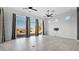 Bright living room with large windows, backyard views, and modern ceiling fans at 14562 W Georgia Ave, Litchfield Park, AZ 85340