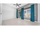 Open living room with tile floors, a ceiling fan, and large windows at 14562 W Georgia Ave, Litchfield Park, AZ 85340