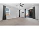 Spacious main bedroom with carpet flooring, a ceiling fan, and sliding glass door access to the patio at 14562 W Georgia Ave, Litchfield Park, AZ 85340