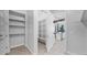 Bright pantry with open shelving and tile flooring, located adjacent to the modern kitchen at 14562 W Georgia Ave, Litchfield Park, AZ 85340
